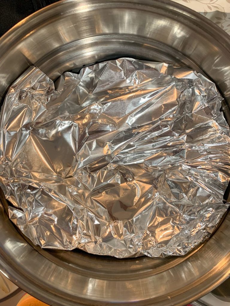 Layer of aluminum foil covering the tamales