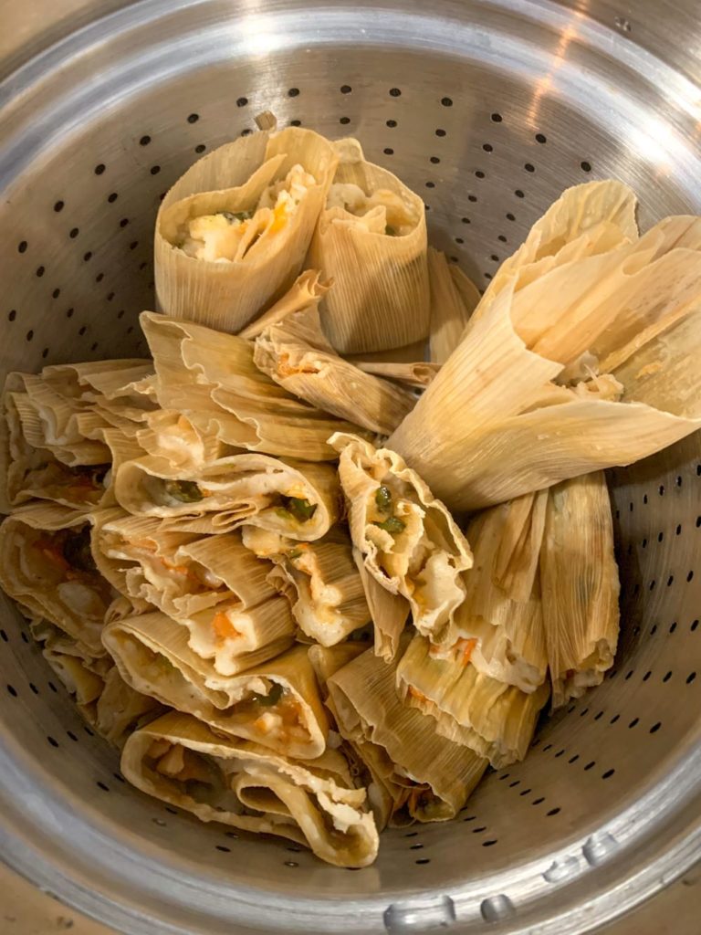 Cooked tamales in a large steamer pot